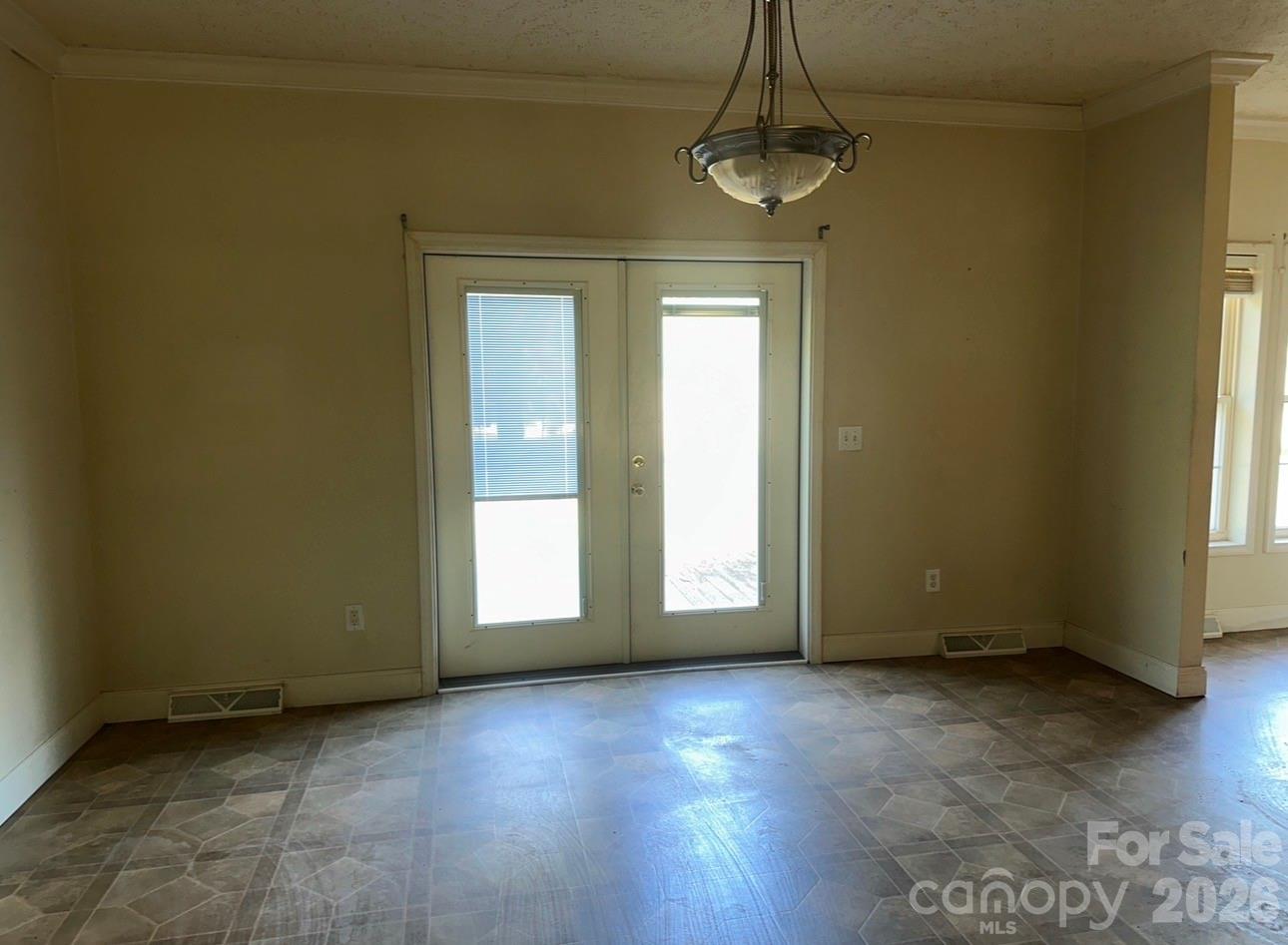 172 Jesse King Road Advance, NC 27006 - Photo 11 of 23 an empty room with wooden floor and windows