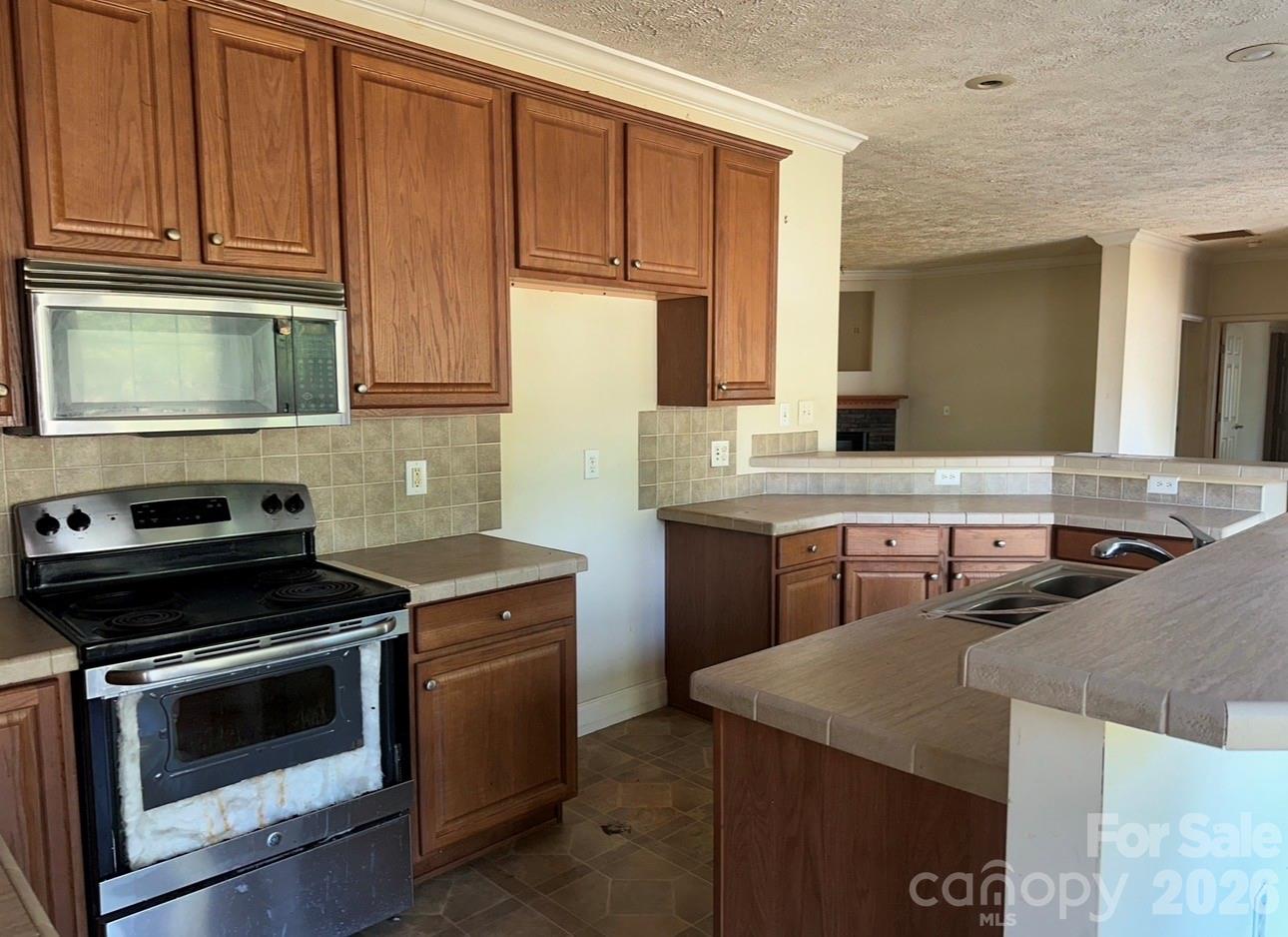 172 Jesse King Road Advance, NC 27006 - Photo 7 of 23 a kitchen with a stove and a microwave