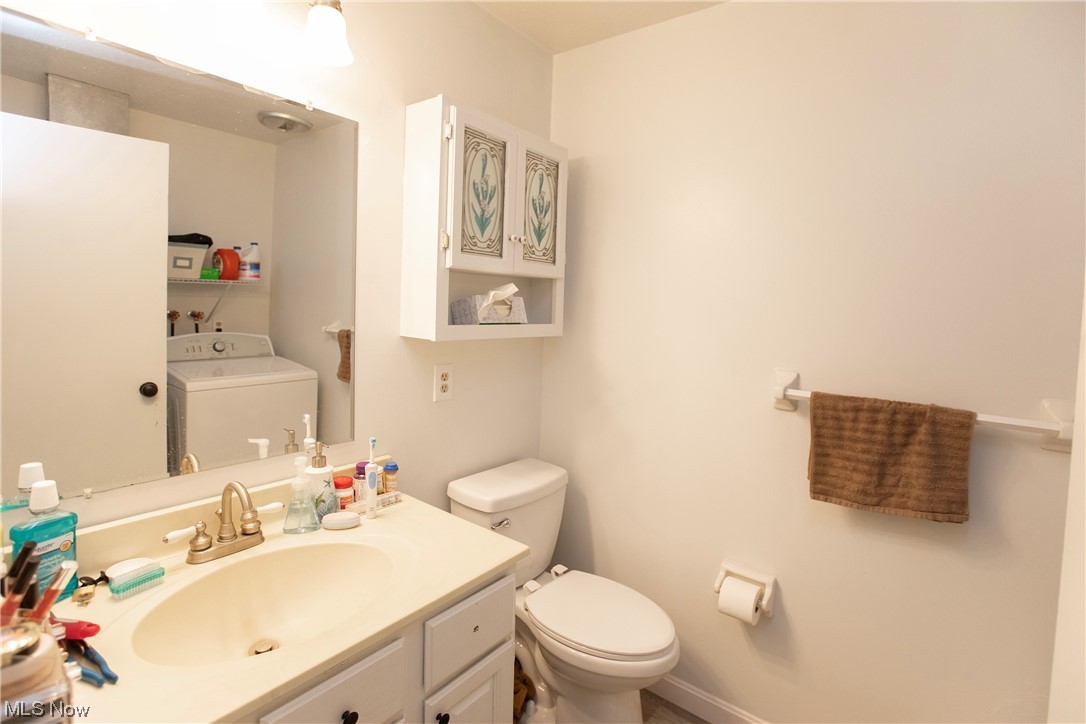 5985 Case Road North Ridgeville, OH 44039 - Photo 14 of 28 Bathroom featuring toilet, washer / clothes dryer, and vanity