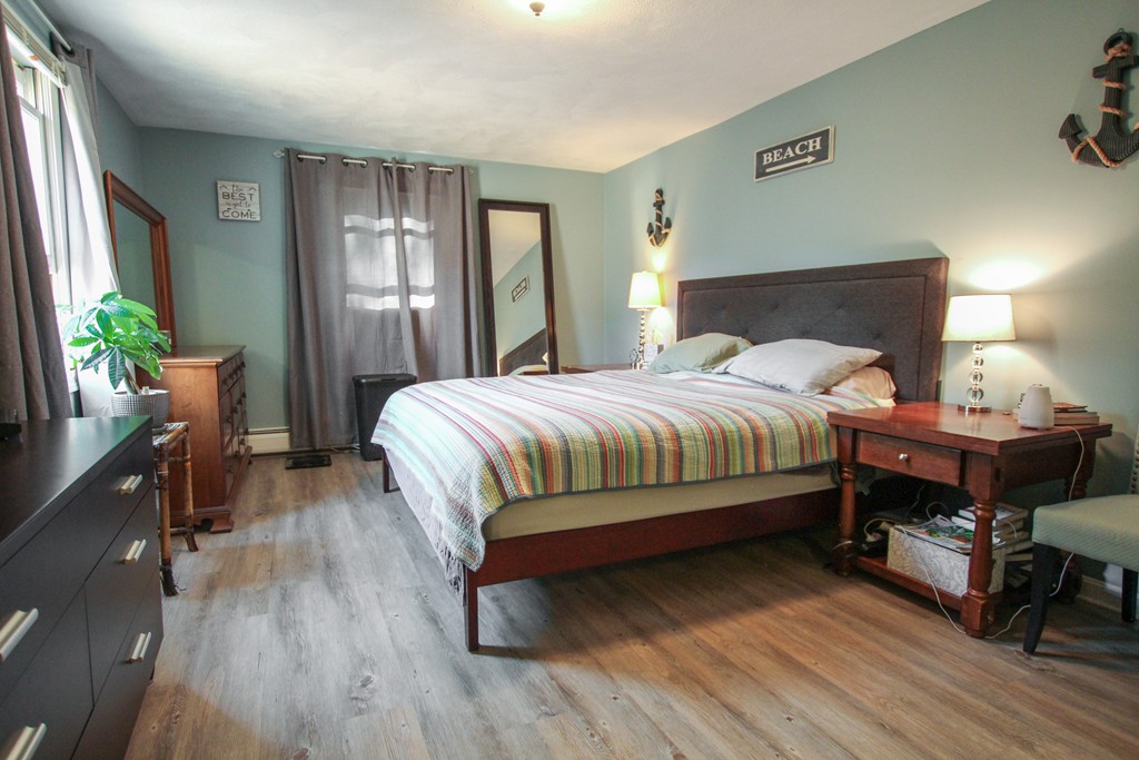19 Coleman Road Newbury, MA 01922 - Photo 16 of 29 a bedroom with a bed and wooden floor