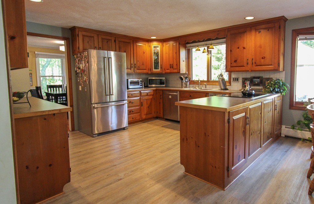 19 Coleman Road Newbury, MA 01922 - Photo 6 of 29 a kitchen with stainless steel appliances granite countertop a refrigerator a sink dishwasher stove and wooden cabinets