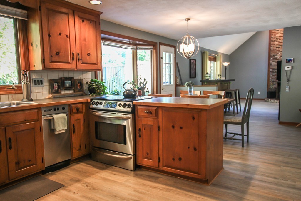 19 Coleman Road Newbury, MA 01922 - Photo 7 of 29 a kitchen with a stove a sink a dining table and chairs