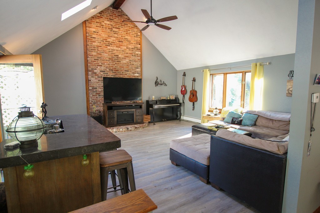 19 Coleman Road Newbury, MA 01922 - Photo 9 of 29 a living room with furniture a flat screen tv and a large window