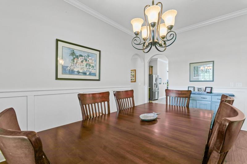 2724 North Portofino Road St. Augustine, FL 32092 - Photo 15 of 86 a view of a dining room with furniture a chandelier and wooden floor