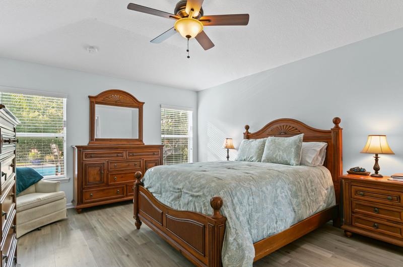 2724 North Portofino Road St. Augustine, FL 32092 - Photo 19 of 86 a bedroom with a bed and a chandelier