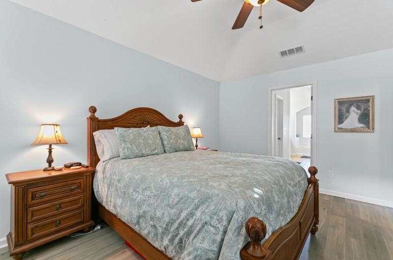 2724 North Portofino Road St. Augustine, FL 32092 - Photo 20 of 86 a bedroom with a bed and wooden floor