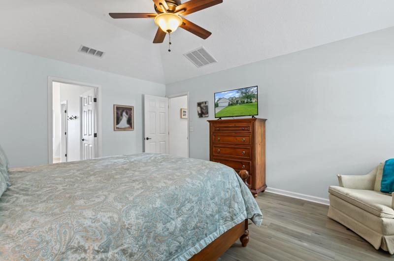 2724 North Portofino Road St. Augustine, FL 32092 - Photo 21 of 86 a bedroom with furniture and a chandelier