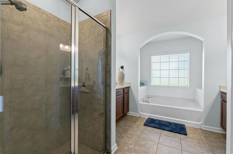 2724 North Portofino Road St. Augustine, FL 32092 - Photo 23 of 86 a bathroom with a bathtub and a shower
