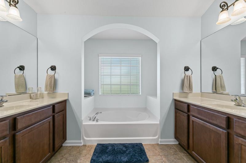 2724 North Portofino Road St. Augustine, FL 32092 - Photo 24 of 86 Full bath with two sinks, vanity, and a bath