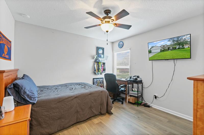 2724 North Portofino Road St. Augustine, FL 32092 - Photo 29 of 86 a bedroom with a bed and a table in it