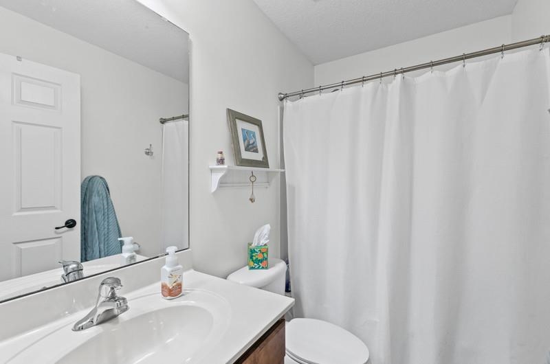 2724 North Portofino Road St. Augustine, FL 32092 - Photo 31 of 86 a bathroom with a sink and a mirror