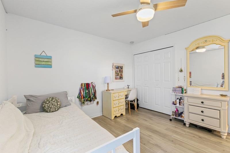 2724 North Portofino Road St. Augustine, FL 32092 - Photo 33 of 86 a bedroom with a bed and a chandelier