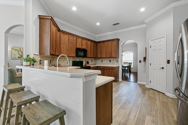 2724 North Portofino Road St. Augustine, FL 32092 - Photo 35 of 86 a kitchen with sink cabinets and wooden floor
