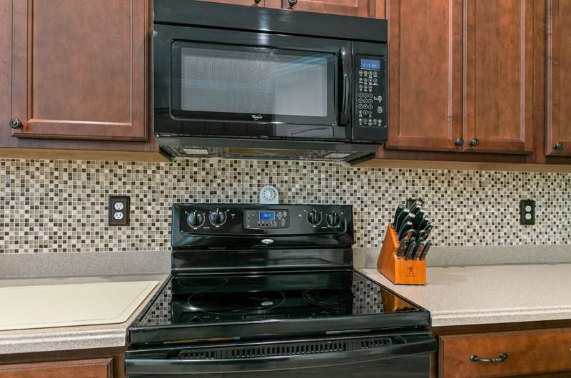 2724 North Portofino Road St. Augustine, FL 32092 - Photo 37 of 86 a kitchen with wooden cabinets and a stove top oven
