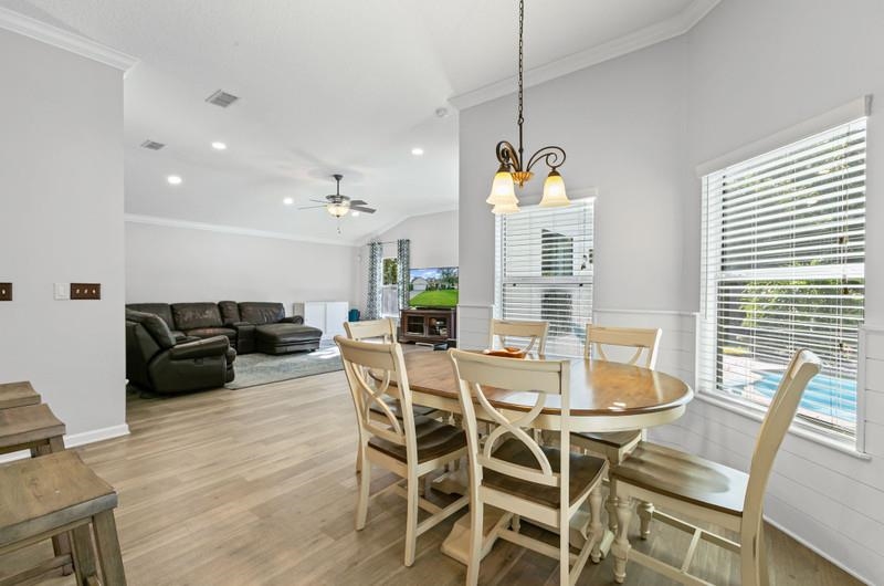 2724 North Portofino Road St. Augustine, FL 32092 - Photo 39 of 86 a view of a dining room with furniture window and wooden floor