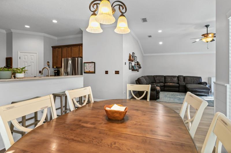 2724 North Portofino Road St. Augustine, FL 32092 - Photo 40 of 86 Dining space with ornamental molding, recessed lighting, ceiling fan, and wood finished floors