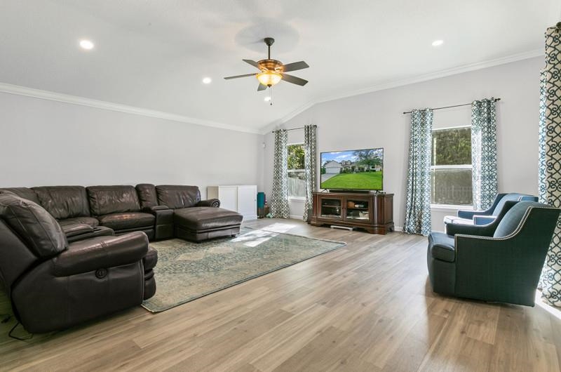 2724 North Portofino Road St. Augustine, FL 32092 - Photo 42 of 86 Living area featuring ornamental molding, light wood finished floors, lofted ceiling, ceiling fan, and recessed lighting