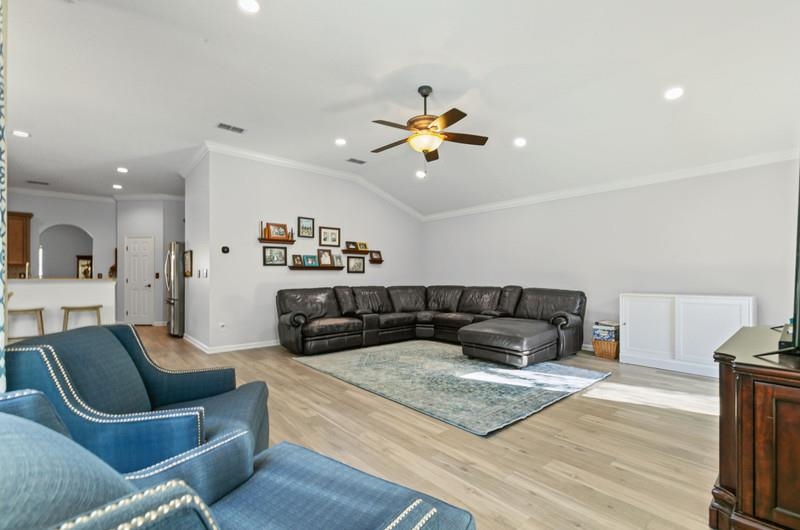 2724 North Portofino Road St. Augustine, FL 32092 - Photo 44 of 86 Living room with ornamental molding, light wood-type flooring, recessed lighting, a ceiling fan, and lofted ceiling