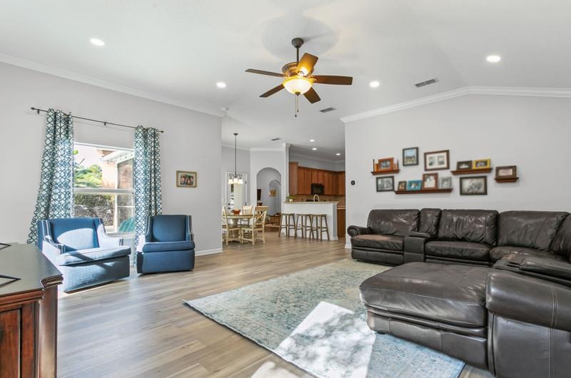 2724 North Portofino Road St. Augustine, FL 32092 - Photo 45 of 86 Living room with ornamental molding, light wood finished floors, ceiling fan, recessed lighting, and arched walkways
