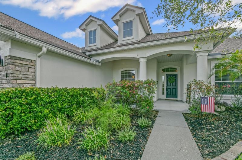 2724 North Portofino Road St. Augustine, FL 32092 - Photo 5 of 86 Property entrance featuring a porch, stucco siding, and a shingled roof