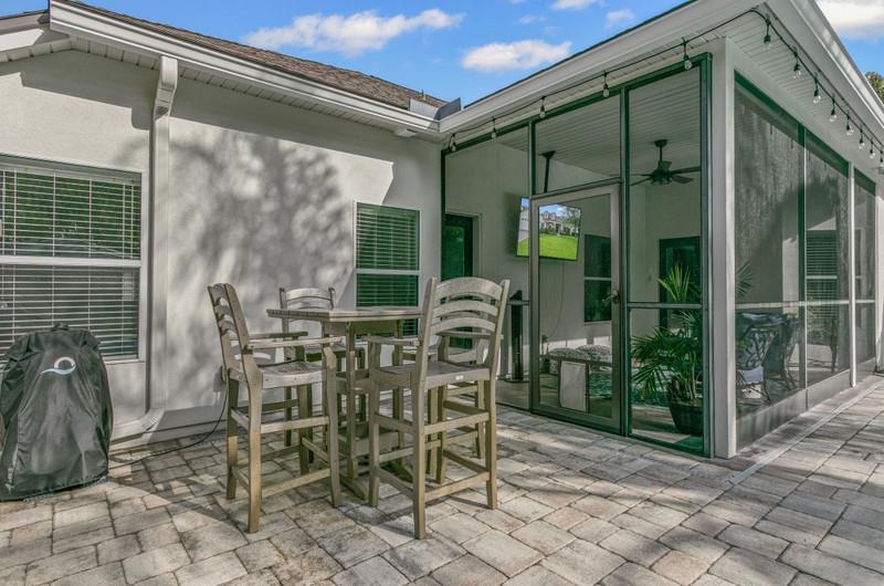 2724 North Portofino Road St. Augustine, FL 32092 - Photo 50 of 86 View of patio / terrace featuring outdoor dining area and a ceiling fan