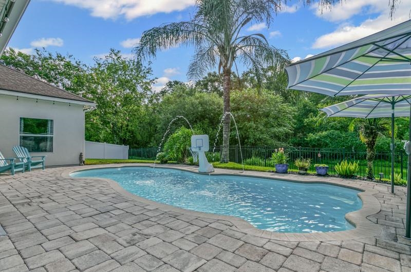 2724 North Portofino Road St. Augustine, FL 32092 - Photo 51 of 86 View of pool with a patio, a fenced backyard, and view of wooded area