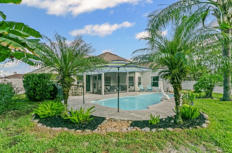 2724 North Portofino Road St. Augustine, FL 32092 - Photo 56 of 86 Rear view of property with a patio area, a sunroom, and an outdoor pool