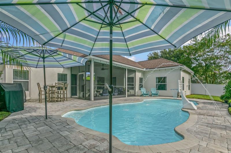 2724 North Portofino Road St. Augustine, FL 32092 - Photo 60 of 86 View of swimming pool featuring a patio, area for grilling, a sunroom, and a ceiling fan