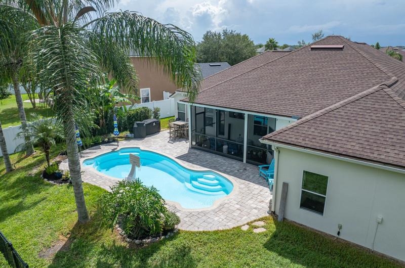 2724 North Portofino Road St. Augustine, FL 32092 - Photo 66 of 86 View of swimming pool with a patio area, a fenced backyard, and a sunroom