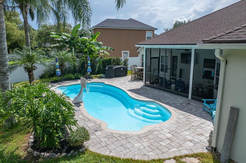 2724 North Portofino Road St. Augustine, FL 32092 - Photo 67 of 86 View of swimming pool with a patio, a sunroom, and a fenced backyard