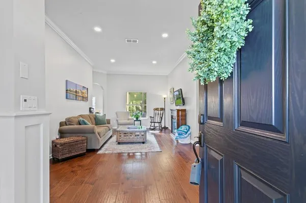 a living room with furniture a window and a flat screen tv