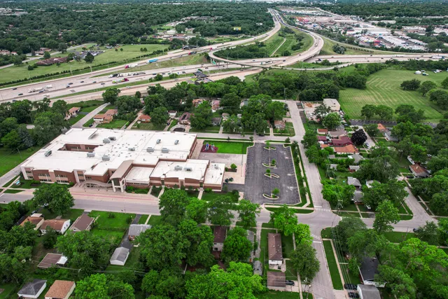 an aerial view of a house with garden space and street view