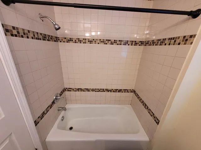 a bathroom with a bathtub and a shower