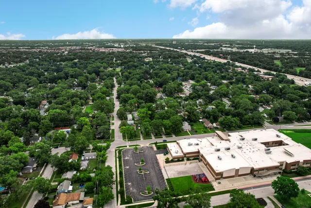 an aerial view of residential houses with outdoor space and ocean view