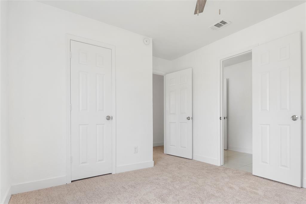 559 Raintree Circle Coppell, TX 75019 - Photo 27 of 40 Neutral-toned carpeting paired with white walls