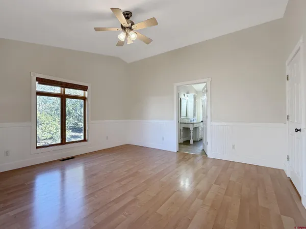 an empty room with wooden floor and a window
