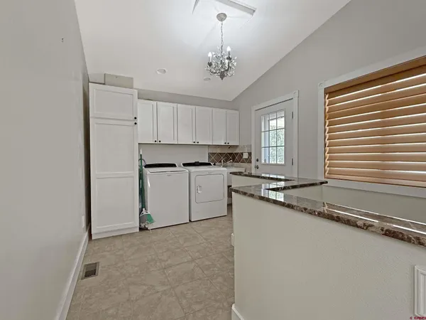 a kitchen with granite countertop a sink stainless steel appliances and cabinets