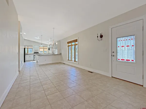a view of a kitchen with furniture and an empty room