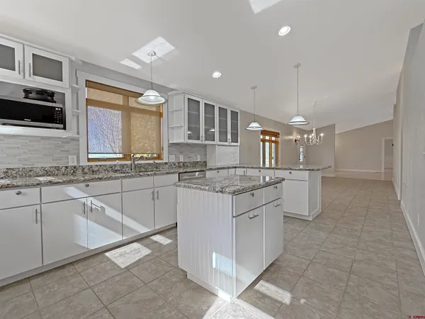 a kitchen with granite countertop counter top space appliances and a cabinets