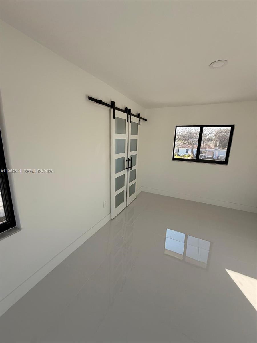 935 Southwest 72nd Avenue Miami, FL 33144 - Photo 12 of 17 an empty room with windows