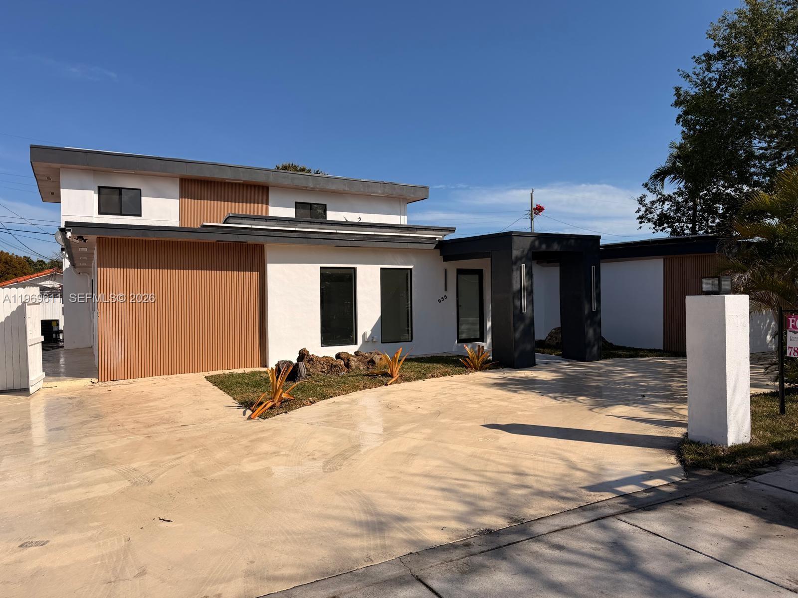935 Southwest 72nd Avenue Miami, FL 33144 - Photo 3 of 17 a front view of a house with a patio