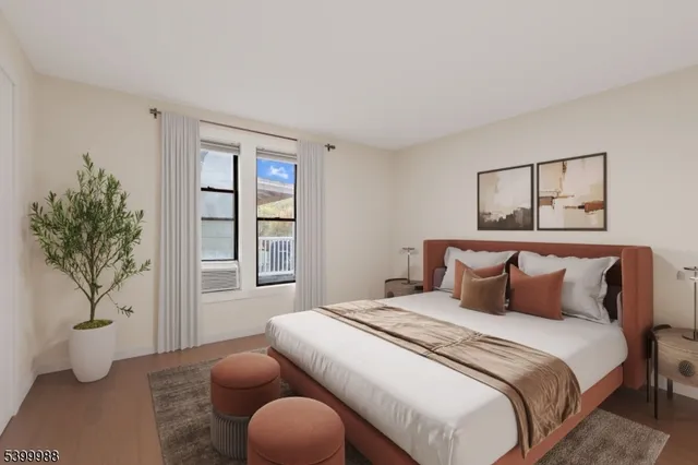 a bedroom with a bed and a potted plant