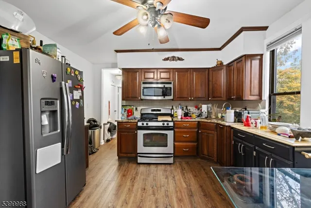 a kitchen with stainless steel appliances a stove refrigerator sink and cabinets