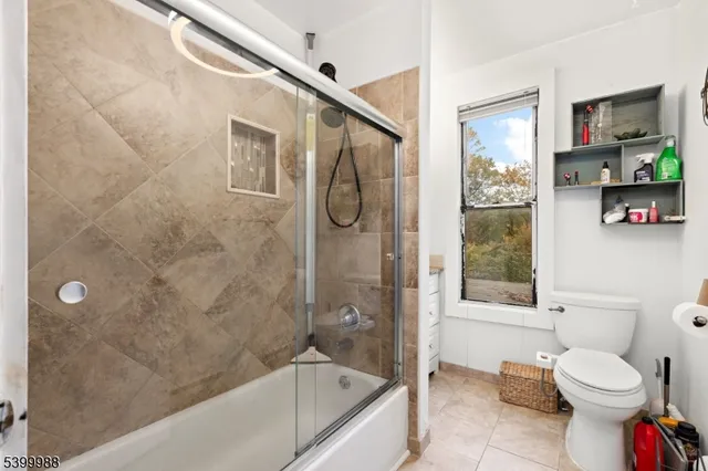 a bathroom with a toilet and shower