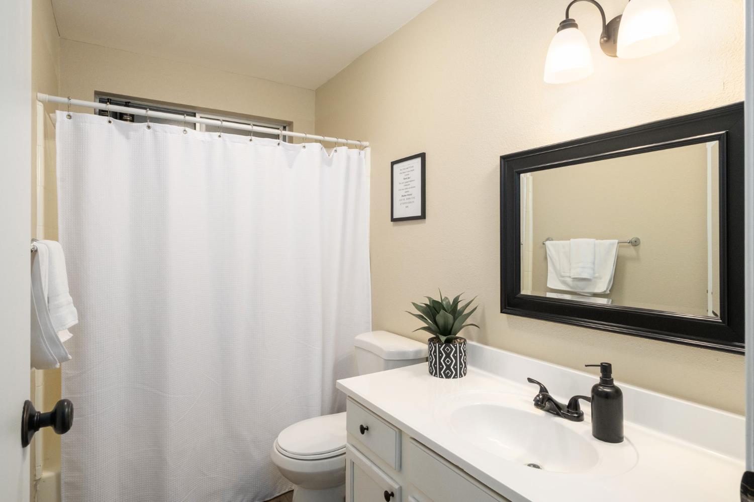 2811 East Westfall Road Mariposa, CA 95338 - Photo 13 of 25 a bathroom with a sink toilet and mirror
