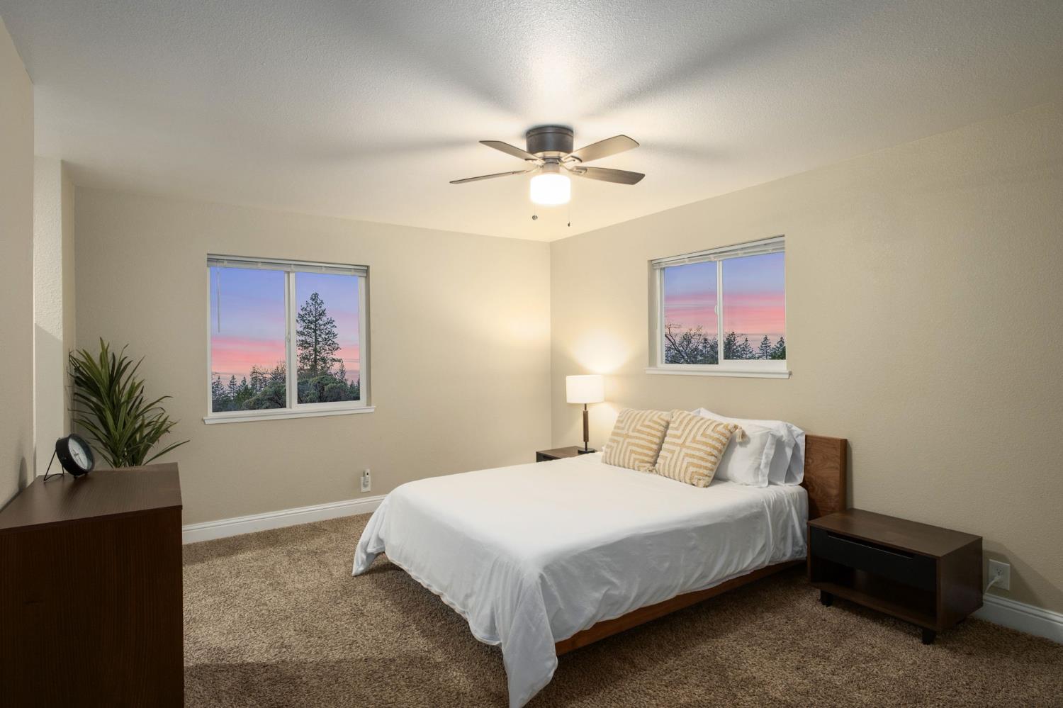 2811 East Westfall Road Mariposa, CA 95338 - Photo 9 of 25 a bedroom with a bed and a chandelier