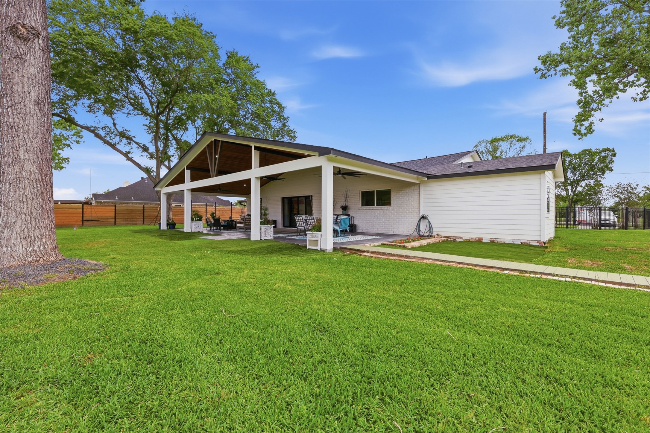 5111 Brookside Road Pearland, TX 77581 - Photo 35 of 42 Expansive backyard overlooking the covered patio and custom firepit area with plenty of room to entertain, play, or add future amenities.