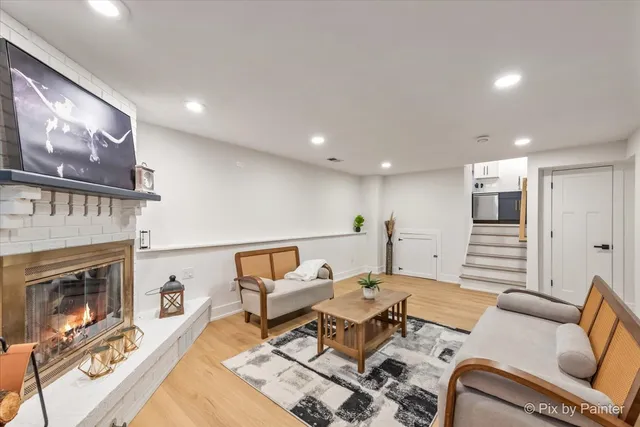 a living room with furniture a fireplace and a flat screen tv