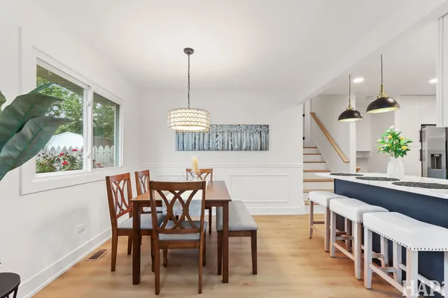 a view of a dining room with furniture window and wooden floor