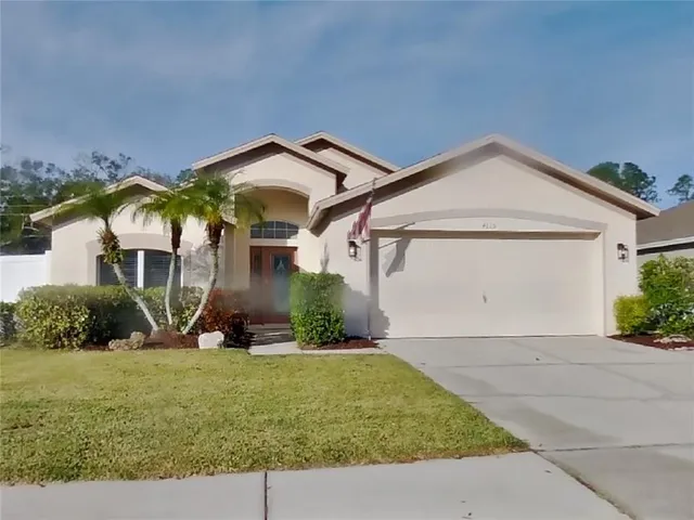 a front view of a house with a yard and garage